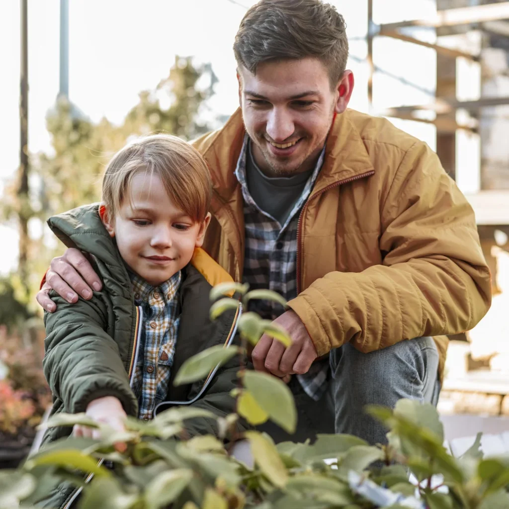 Gentle Parenting vs Traditional Parenting: Which Approach is More Effective? 12 Parent and child planting a tree, representing the growth of emotional resilience and discipline